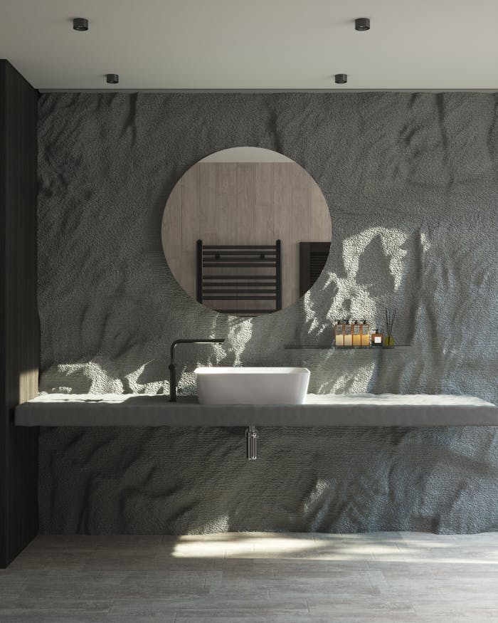 Elegant bathroom design with textured gray wall and round mirror.
